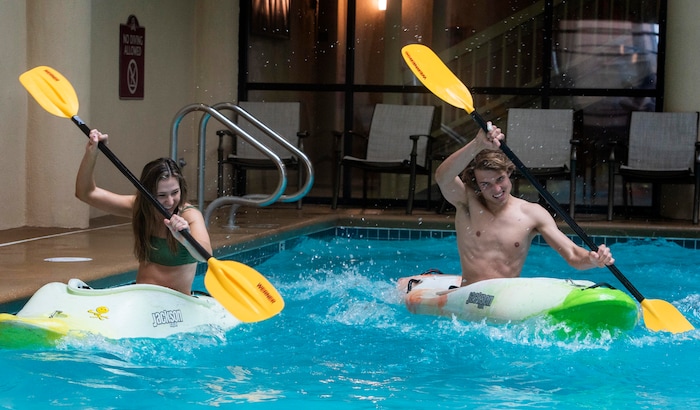 (Rick Egan | The Salt Lake Tribune) Carly and Kam Kelson, race kayaks across the swimming pool at Ruby's Inn, during the kayak demonstration at the 36th annual Ruby's Inn Bryce Canyon Winter Festival on Saturday, Feb. 13, 2021.