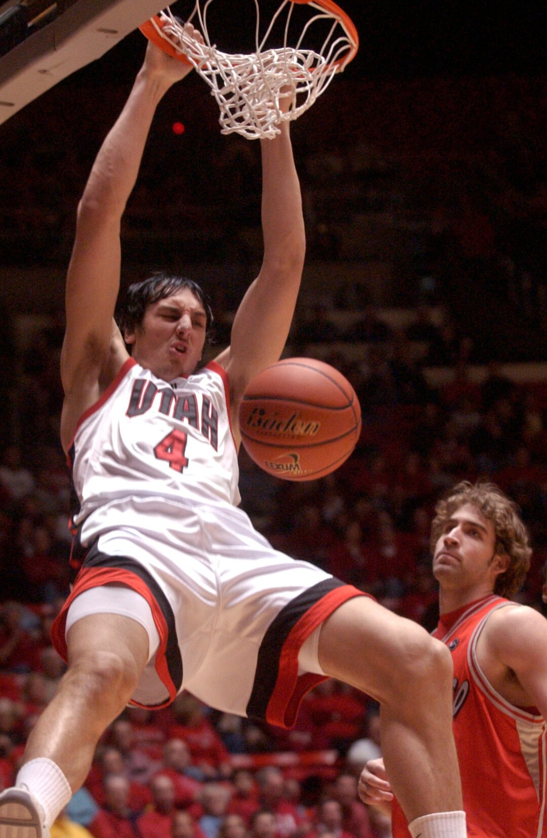 The University of Utah men's basketball team defeated University of New Mexico 69-58 Saturday at the Huntsman Center. Above, the Utes' Andrew Bogut skies above Lobos' David Chiotti for the dunk. Photo taken by Leah Hogsten 1/22/05