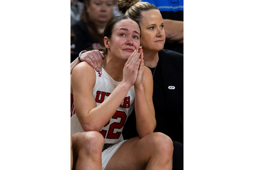 (Mic Smith | AP) Utah's Jenna Johnson (22) holds back tears and is comforted by coach Lynne Roberts after missing two free throws late in the second half against LSU in a Sweet 16 college basketball game of the women's NCAA Tournament in Greenville, S.C., Friday, March 24, 2023.