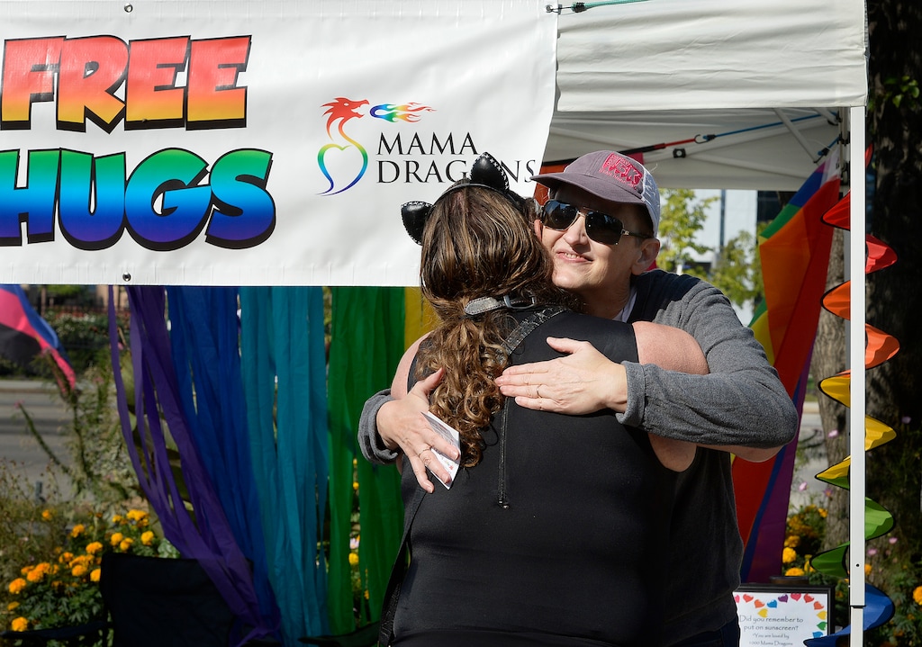 (Scott Sommerdorf   |  The Salt Lake Tribune) Neca Allgood, President of Mama Dragon gives out one of the free hugs at the Mama Dragon booth at the fifth annual Provo Pride Festival, Saturday, September 16, 2017.