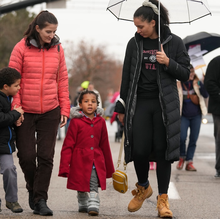 (Leah Hogsten | The Salt Lake Tribune) Asha Brown and her son William Hall, 3, right, participate in the march from East High School to Kingsbury Hall on Monday. To commemorate the legacy and work of Martin Luther King, Jr. and many other activists fighting for racial equality during the Civil Rights movement, the University of Utah's office of Equity, Diversity & Inclusion kicked off MLK Week 2023 with a rally at East High School, followed by a march to Kingsbury Hall, Jan. 16, 2023. 