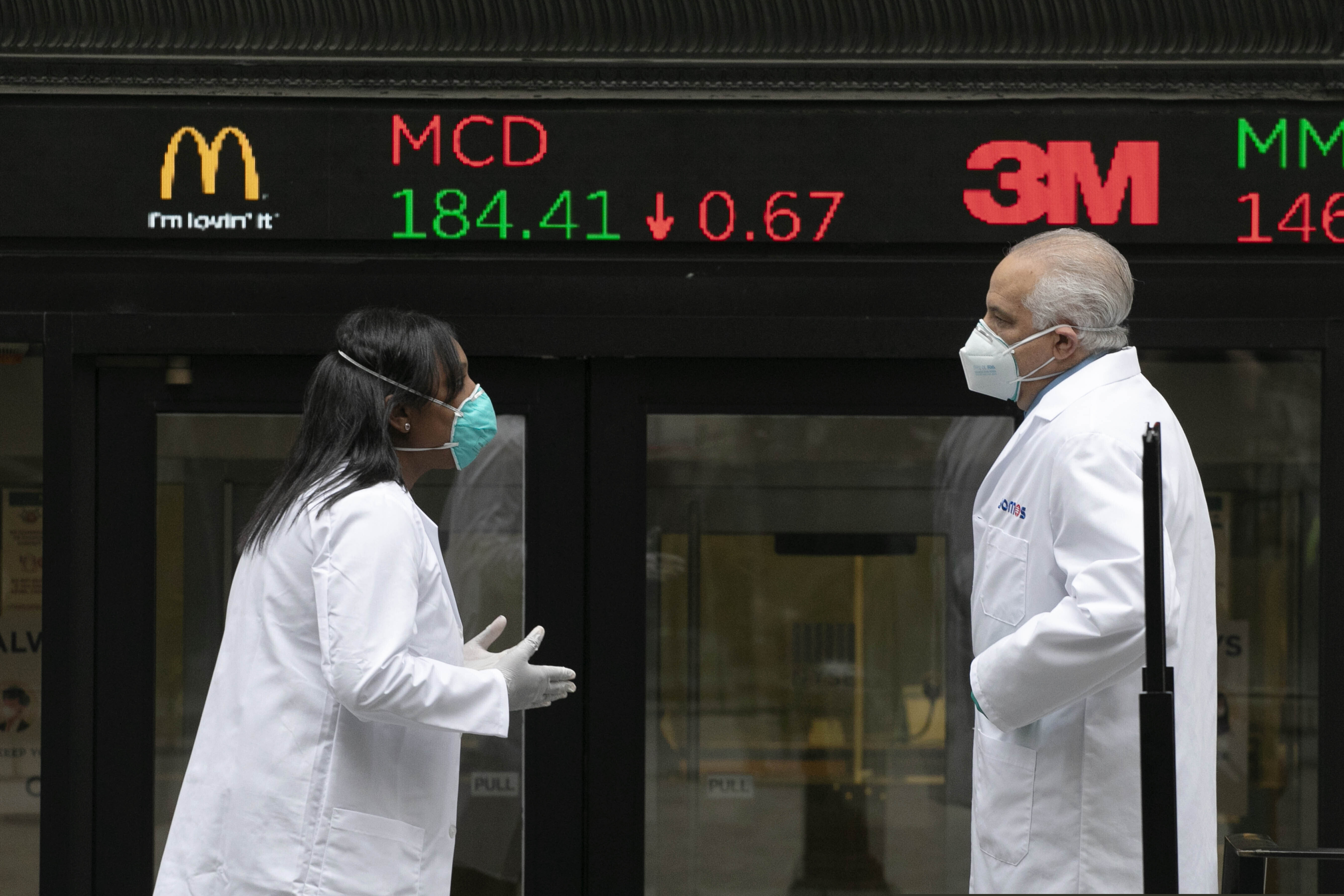 Mark Lennihan | AP Images for The New York Stock Exchange

Health care screeners talk outside the New York Stock Exchange, as the trading floor partially reopens on Tuesday, May 26, 2020, in New York. The floor, known worldwide for an anarchic atmosphere with traders shouting orders over one another, has been closed since mid-March due to the coronavirus outbreak. The NYSE says fewer traders will be on the floor at a given time for now in order to support six-feet social distancing requirements. They also must wear masks.