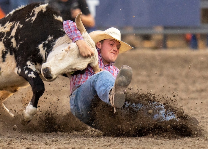 (Rick Egan | The Salt Lake Tribune)  Mason Couch, Cassville, Mo., competes in the steer wrestling competition at the Utah Days of '47 Rodeo at the State Fairpark, on Monday, July 25, 2022.