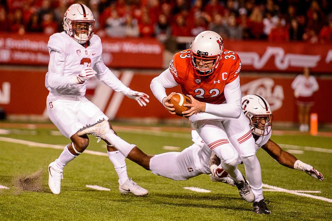 (Trent Nelson | The Salt Lake Tribune)  Utah Utes punter Mitch Wishnowsky (33) is brought down losing control of the ball as the University of Utah hosts Stanford, NCAA football at Rice-Eccles Stadium in Salt Lake City Saturday October 7, 2017.