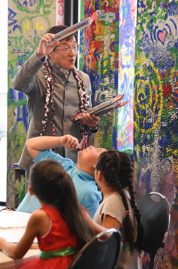 (Francisco Kjolseth | The Salt Lake Tribune) Jackie Chan meets with Mountain View Elementary students as he hands out rulers with an embedded strip of recycled film from one of his movies making every one unique during a workshop as part of a preview of Jackie ChanÕs Inaugural Environmental Exhibition ÔJackie Chan: Green HeroÕ at The Leonardo: Museum of Creativity and Innovation on Thursday, Jan. 24, 2019.