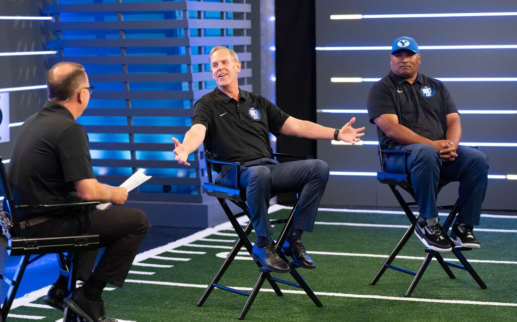 (Francisco Kjolseth | The Salt Lake Tribune) BYU athletic director Tom Holmoe, center, is joined by head football coach Kalani Sitake as they go on live tv programming for BYU Football Media Day at the BYU Broadcasting Building in Provo on Thursday, June 17, 2021.