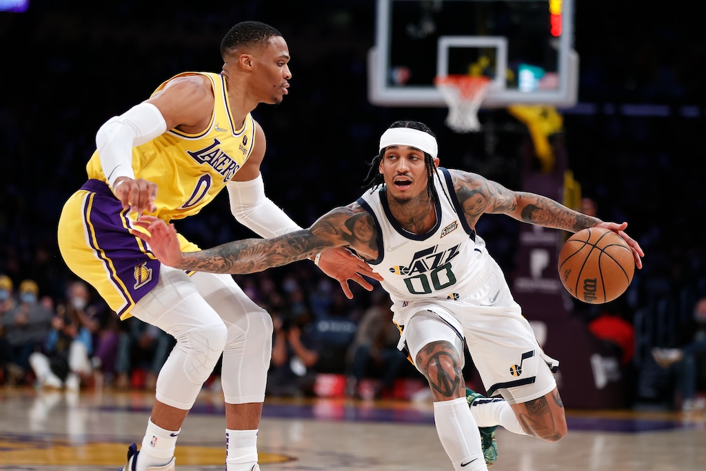 Utah Jazz guard Jordan Clarkson (00) drives past Los Angeles Lakers guard Russell Westbrook (0) during the first half of an NBA basketball game in Los Angeles, Monday, Jan. 17, 2022. (AP Photo/Ringo H.W. Chiu)