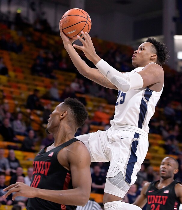 Utah State forward Dwayne Brown Jr. (25) drives to the basket as UNLV forward Shakur Juiston (10) and guard Jordan Johnson (24) defend during an NCAA college basketball game Saturday, March 3, 2018, in Logan, Utah. (Eli Lucero/The Herald Journal via AP)