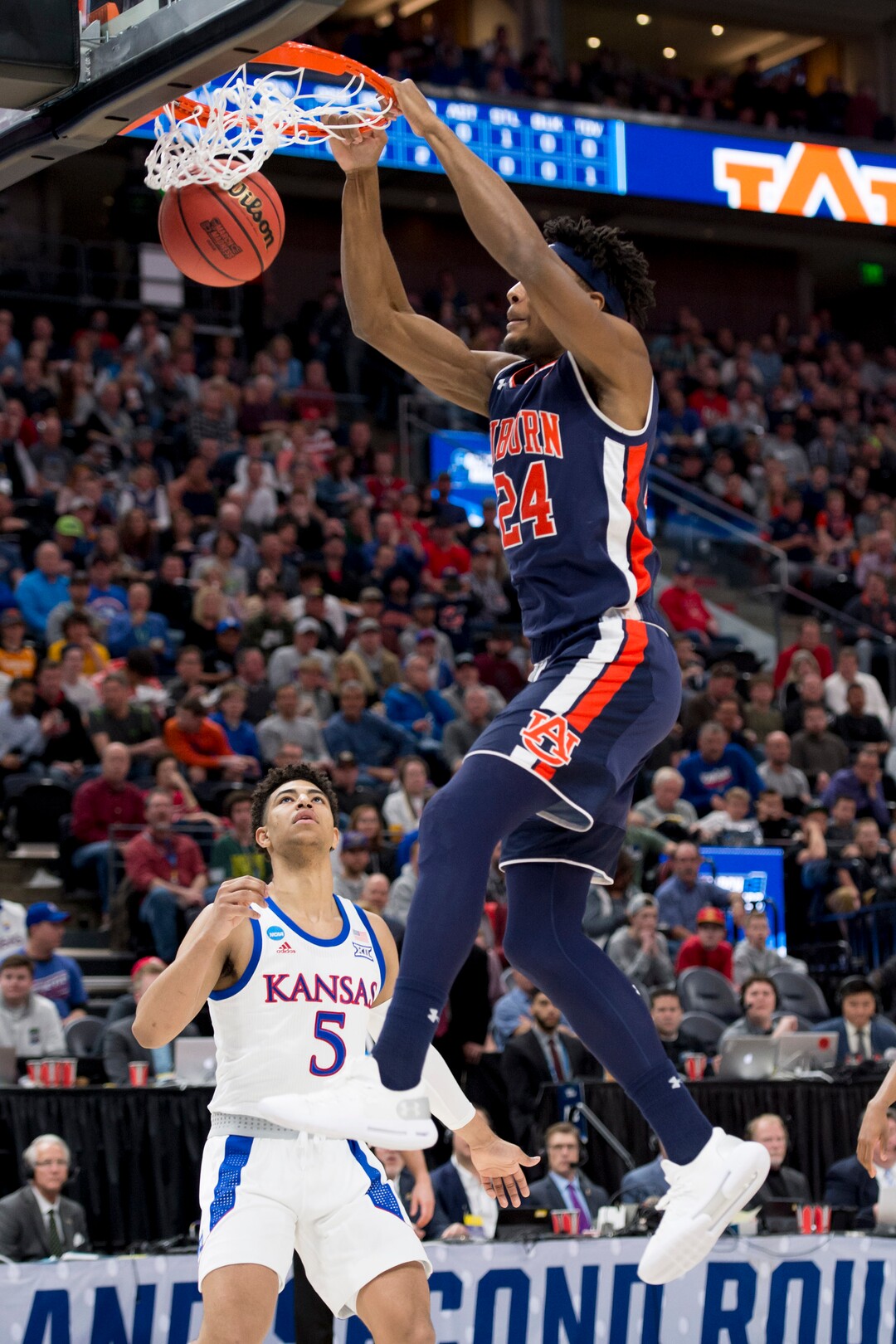 (Leah Hogsten  | The Salt Lake Tribune)  Auburn Tigers forward Anfernee McLemore (24) dunks over Kansas Jayhawks guard Quentin Grimes (5) as Auburn faces Kansas in the second round of the NCAA tournament in Salt Lake City on Saturday, March 23, 2019.