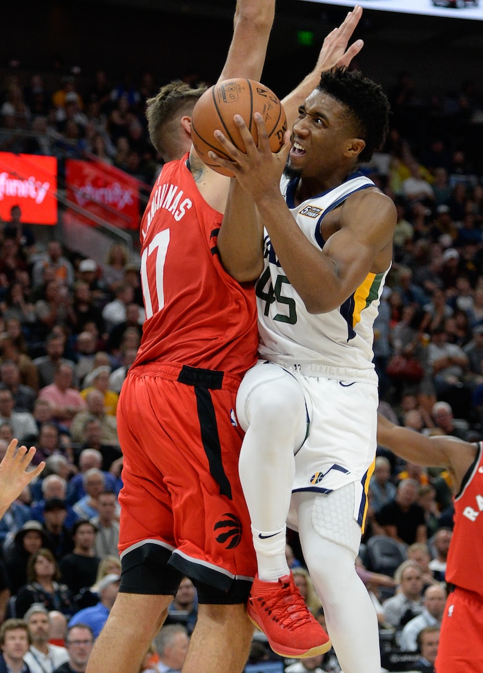 (Francisco Kjolseth  |  The Salt Lake Tribune)  Utah Jazz guard Donovan Mitchell (45) tries to drive the ball past the Raptors in the first half of the preseason NBA game at Vivint Smart Home Arena Tuesday, Oct. 2, 2018, in Salt Lake City.
