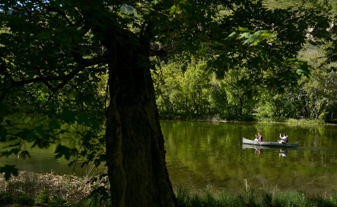 (Leah Hogsten  |  The Salt Lake Tribune) BSA Camp Tracy employees James Jette, 18, and Hensley Ballamis paddle around Taylor Lake, Thursday, May 24, 2018. The two will serve as lifeguards at Camp Tracy for the 2018 summer season. 