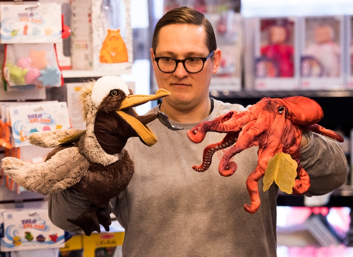 (Rick Egan  |  The Salt Lake Tribune)       Casey Sartain demonstrates some of the unique toys they sell at The Tutoring Toy on Foothill Drive, such as Folkmanis Puppets.  Thursday, March 22, 2018.