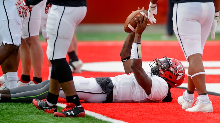(Steve Griffin  |  The Salt Lake Tribune) Utah quarterback Tyler Huntley holds up the ball after scoring on a short run during the University of Utah football team's first scrimmage at Rice-Eccles Stadium in Salt Lake City Friday March 30, 2018.