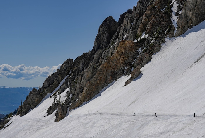(Francisco Kjolseth  | The Salt Lake Tribune) Skiers make the traverse in Mineral Basin as Snowbird closes the book on the 2024-25 ski season on Monday, May 26, 2025. Snow and sun revelers took to the slushy slopes on Memorial Day as the resort was the last in the state to close.