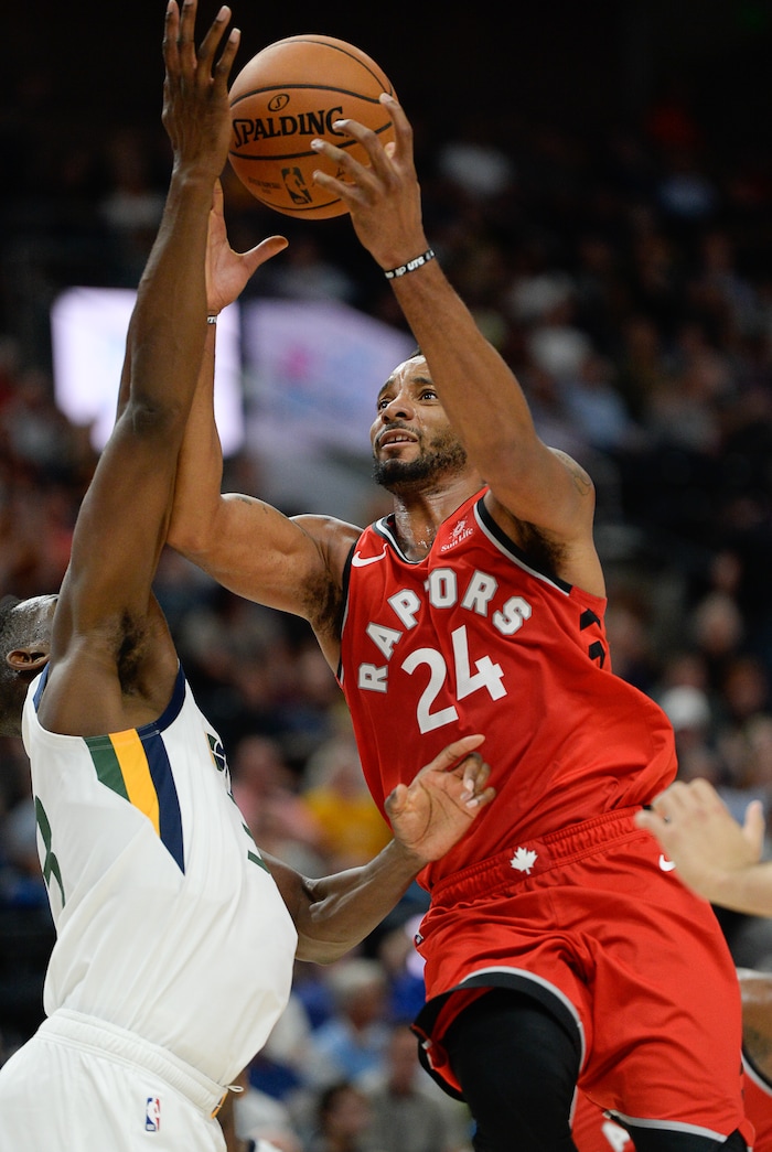 (Francisco Kjolseth  |  The Salt Lake Tribune) Toronto Raptors forward Norman Powell (24) pushes past Utah Jazz center Ekpe Udoh (33) in the second half of the preseason NBA game at Vivint Smart Home Arena Tuesday, Oct. 2, 2018, in Salt Lake City.