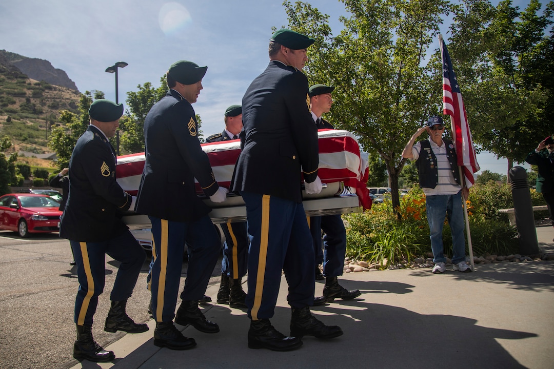 Military personnel carry the remains of Army Sgt. 1st Class Elliott Robbins in a funeral procession on Thursday, July 18, 2019 in Ogden, Utah. Robbins died in a non-combat incident on June 30 while serving in Afghanistan. (Ben Dorger/Standard-Examiner via AP)