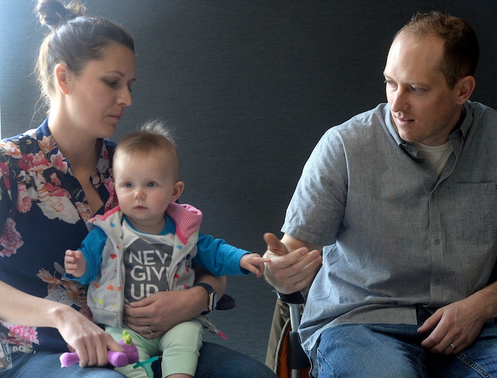 Al Hartmann  |  The Salt Lake Tribune  Janell and Elliot Lewis play with their baby Evie at a press conference at the Utah Public Health Laboratory Wednesday Jan. 31. Evie was was tested for spinal muscular atrophy because the Lewis' first daughter Blakely died from the genetic mutation. Evie received treatment for the condition early on.  The Utah Department of Health announced they're going to start testing every infant born in the state for spinal muscular atrophy. The neurodegenerative disease is the leading genetic cause of death for infants, affecting one in 11,000.  