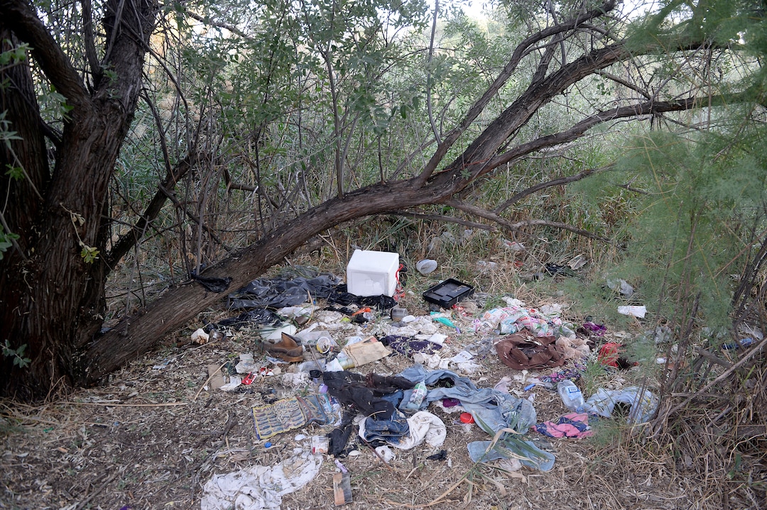 (Al Hartmann  |  The Salt Lake Tribune)  After Operation Rio Grande, homeless camps have popped up everywhere.  Some of the homeless have set up camps in the thick vegetation near the Jordan River south of 3900 South and 900 West, just 50 yards off the Jordan River Parkway Trail.  Camps are full of garbage, tarps, coolers and sleeping bags.  Disposal of human waste at the camps is a health problem.
