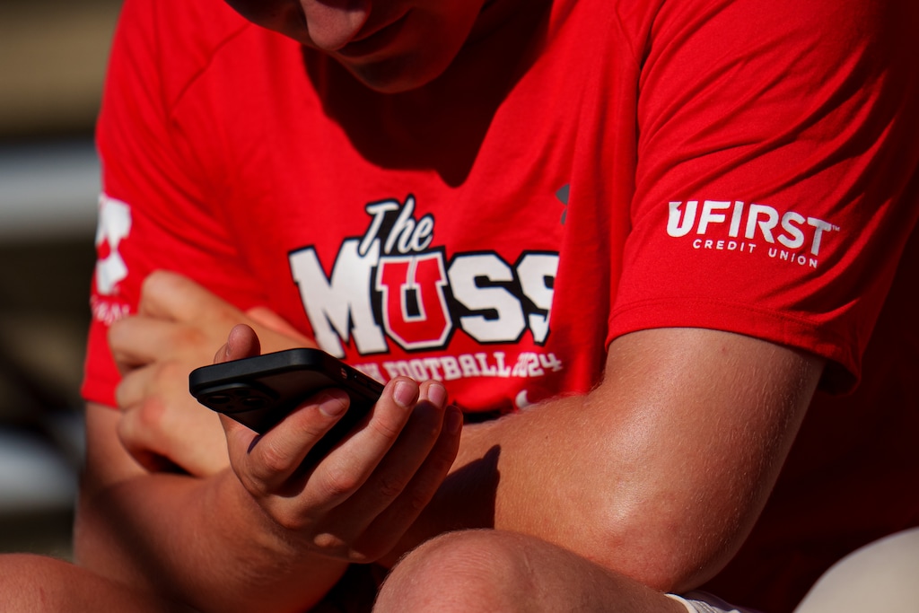 (Trent Nelson  |  The Salt Lake Tribune) A Utah fan looking at their phone as the Utah Utes host the Southern Utah Thunderbirds, NCAA football in Salt Lake City on Thursday, Aug. 29, 2024.