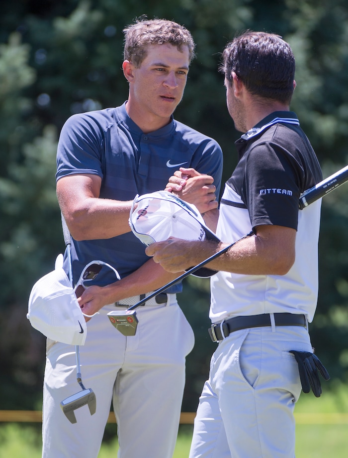 (Rick Egan  |  The Salt Lake Tribune)     Cameron Champ from Sacrament, CA, shakes hands with Julián Etulain, after finishing round two at 17-under-par, at the Championship golf event on the Web.com Tour at Oakridge Country Club in Farmington. July 13, 2018.


