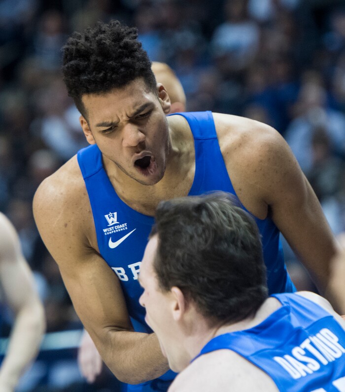 (Rick Egan  |  The Salt Lake Tribune)  Brigham Young Cougars forward Yoeli Childs (23) reacts as he helps Brigham Young Cougars forward Payton Dastrup (15) to his feat after he drew an offensive foul, in basketball action Utah Utes vs. Brigham Young Cougars at the Marriott Center in Provo, Saturday, December 15, 2017.


