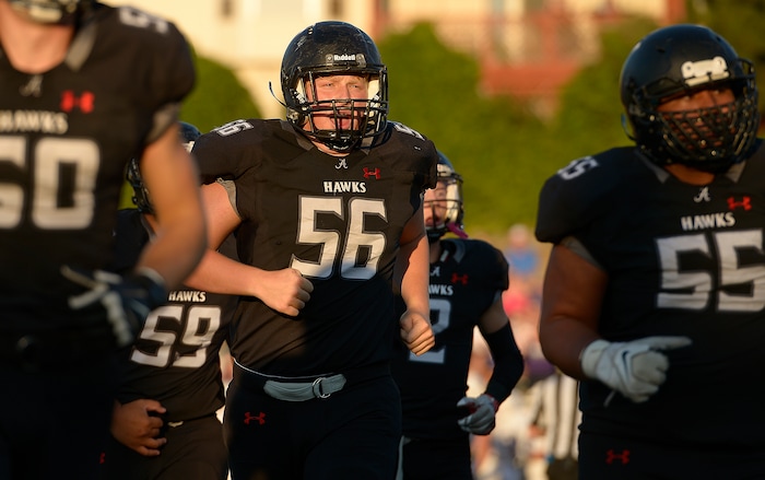 (Leah Hogsten  |  The Salt Lake Tribune) Alta's center Dallin Denning tries to fire up his teammates.  Lehi High School leads Alta High School 35-21 at the half during their game, Friday, August 18, 2017 in Sandy. 