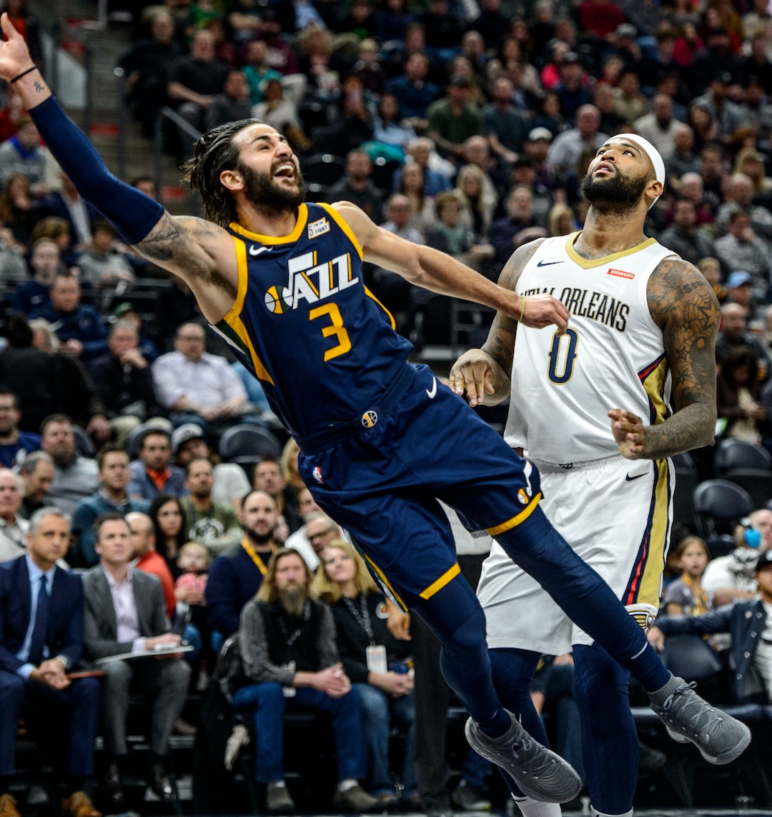 (Steve Griffin  |  The Salt Lake Tribune) Utah Jazz guard Ricky Rubio (3) gets sent flying after crashing into New Orleans Pelicans center DeMarcus Cousins (0) during the the Utah Jazz versus the New Orleans Pelicans NBA basketball game at the Vivint Smart Home Arena in Salt Lake City Wednesday January 3, 2018.