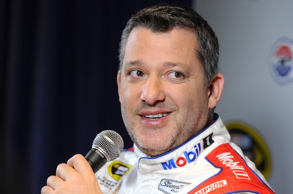 FILE - In this Jan. 21, 2016, file photo, Stewart Haas co-owner and driver Tony Stewart talks to members of the media during the NASCAR Charlotte Motor Speedway Media Tour in Charlotte, N.C. With four-time champion Jeff Gordon retired and three-time champ Tony Stewart sidelined with a broken back, the NASCAR season begins with a much different look and a new rules package. (AP Photo/Mike McCarn, File)