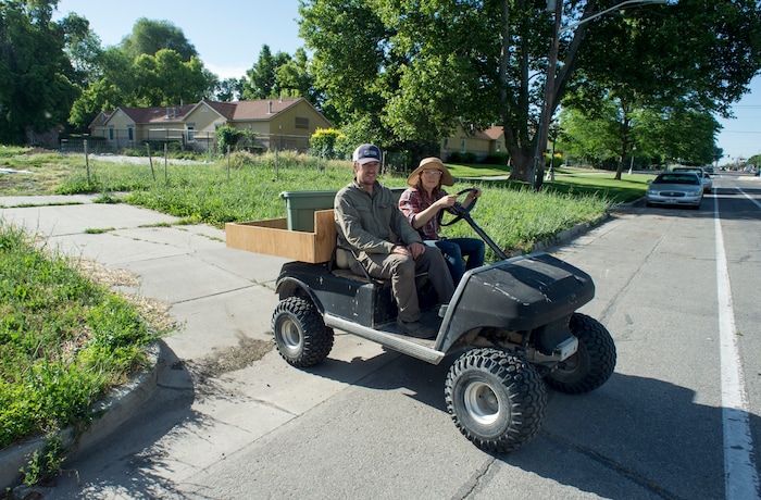 (Rick Egan  |  The Salt Lake Tribune)      Elliot Musgrove and Amanda Theobald, owners of Top Crops ride across the street to their urban farm, in Salt Lake City, Tuesday, June 5, 2018.


