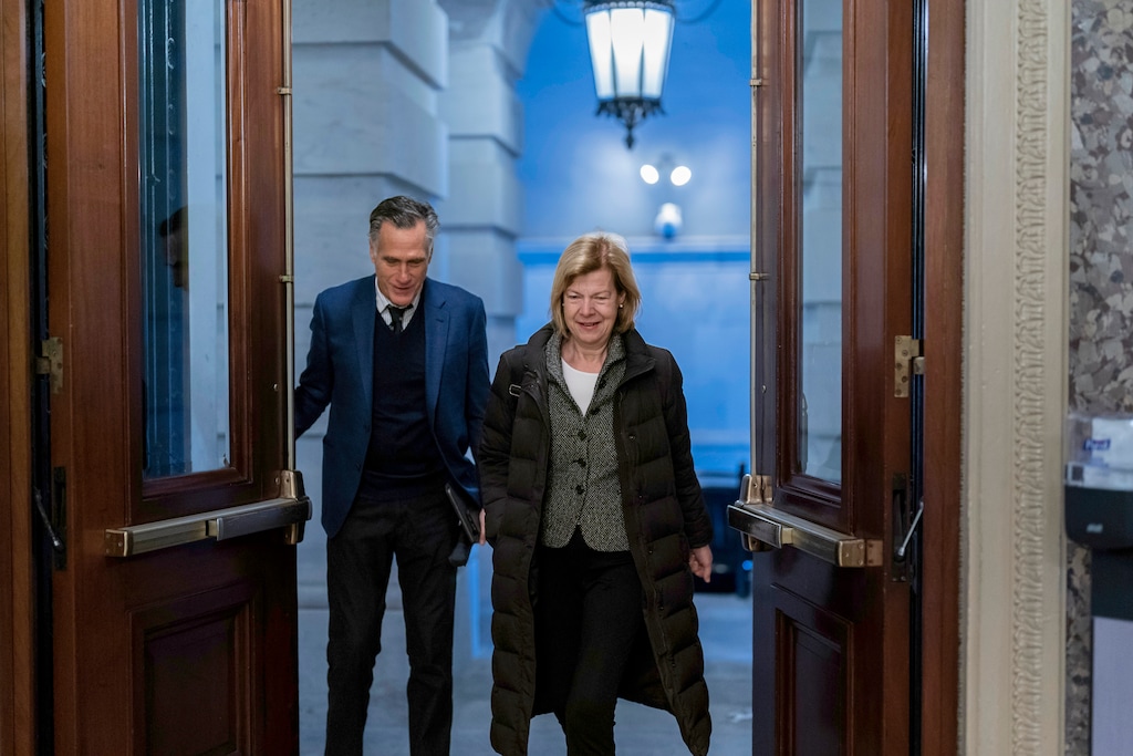 (J. Scott Applewhite | AP) Sen. Mitt Romney, R-Utah, left, and Sen. Tammy Baldwin, D-Wisc., arrive as lawmakers rush to complete passage of a spending bill to fund the government before a midnight Friday deadline or face the prospect of a partial government shutdown going into the Christmas holiday, at the Capitol in Washington, Thursday, Dec. 22, 2022.