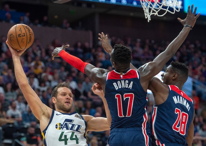 (Rick Egan  |  The Salt Lake Tribune)  Utah Jazz forward Bojan Bogdanovic (44) is double-teamed by Washington Wizards forward Isaac Bonga (17) and Washington Wizards center Ian Mahinmi (28), in NBA action between the Utah Jazz and the Washington Wizards, in Salt Lake City, Friday, February 28, 2020