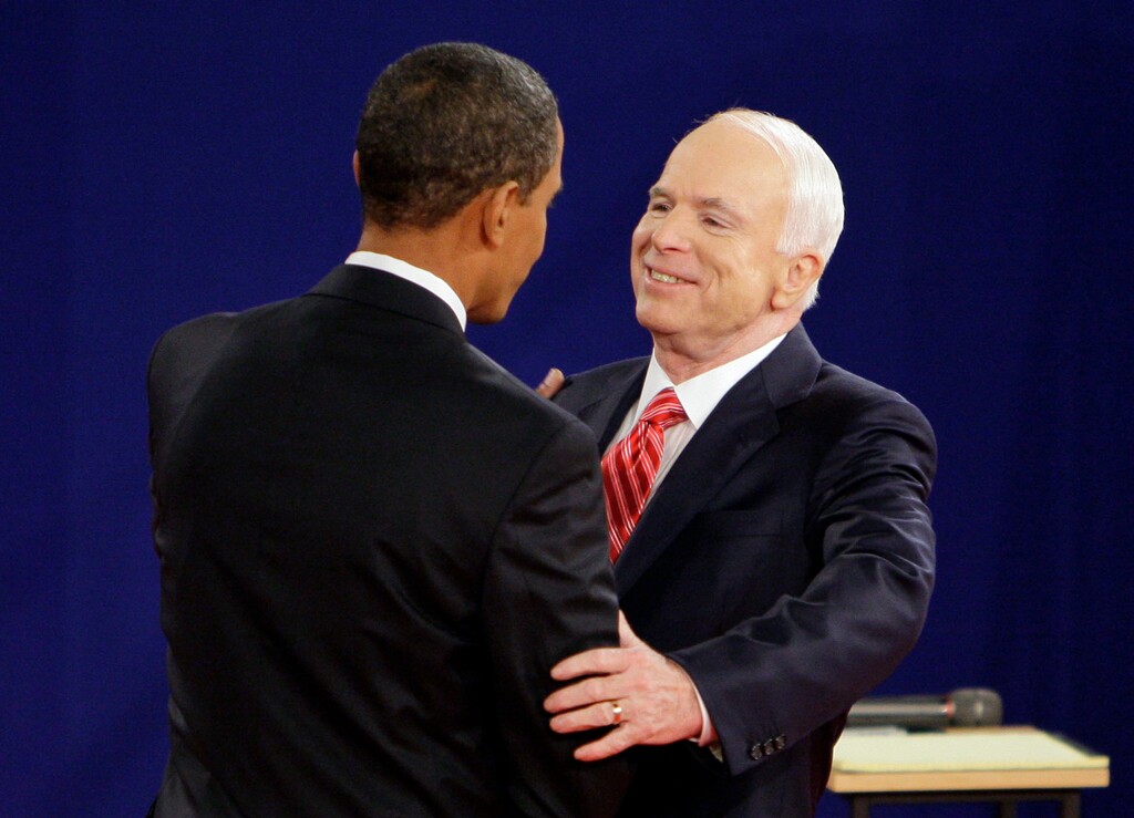 (Mark Humphrey | The Associated Press) In this Oct. 7, 2008, file photo, Democratic presidential candidate Sen. Barack Obama, D-Ill., left, and Republican presidential candidate Sen. John McCain, R-Ariz., greet each other at the start of a townhall-style presidential debate at Belmont University in Nashville, Tenn. Aide says senator, war hero and GOP presidential candidate McCain died Saturday, Aug. 25, 2018. He was 81.