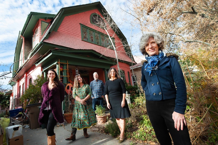 (Francisco Kjolseth  |  The Salt Lake Tribune) Greta deJong, right, longtime publisher of Catalyst magazine is joined by her staff outside of the magazine’s HQ, a large pink house called “Big Pink.” Pictured are Sophie Silverstone, communications outreach director, Polly Mottonen, art director, John deJong, associate publisher, and Jenn Blum, content and communications manager, from left. Catalyst magazine, a Salt Lake City-based magazine for wellness and other New Age topics, is ending its print run after nearly 40 years — shifting to online publication.