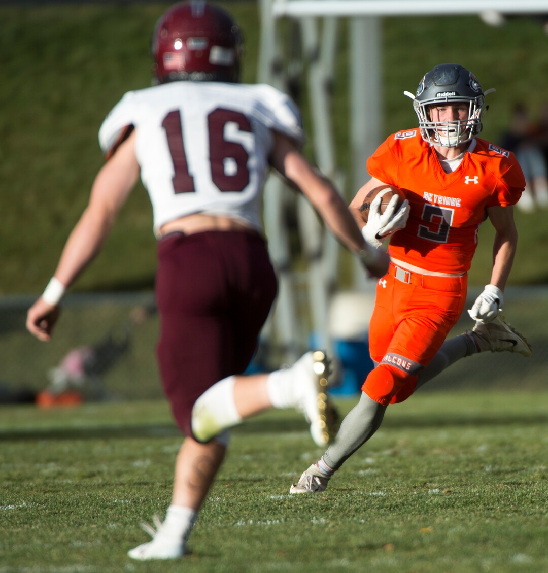 (Rick Egan  |  The Salt Lake Tribune)      Skyridge wider receiver returns a kick off, as Jordan defensive back Truman  Peterson defends, in prep 5A playoff action between Jordan High and Skyridge High, in Lehi, Friday, Nov. 2, 2018.