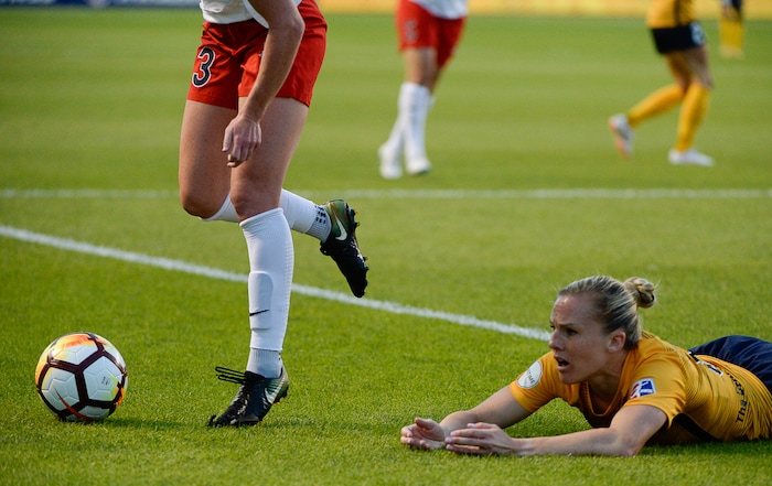(Francisco Kjolseth  |  The Salt Lake Tribune)  Utah Royals FC hosts Washington Spirit, NWSL soccer at Rio Tinto Stadium in Sandy, Wed. Aug. 8, 2018. Utah Royals FC forward Amy Rodriguez (8) takes a tumble while defended by Washington Spirit midfielder Tori Huster (23), losing part of her shoe, during the first half of the game. 