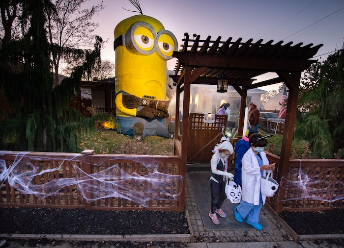 (Francisco Kjolseth  |  The Salt Lake Tribune) Ammon Smith dressed as the villain Balthazar Bratt from the movie Despicable Me goes big with his creation of a 25-foot Kevin, complete with fart gun in Sugar House on Saturday, Oct. 31, 2020, where he used a long tube to deliver candy for kids in an effort to stay safe during COVID-19 for this Halloween.