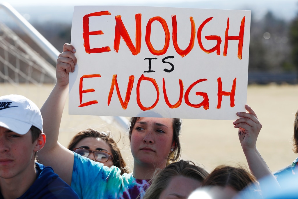 (David Zalubowski | The Associated Press) In this March 14, 2018, file photograph, 15-year-old Leah Zundel waves a placard during a student walkout to protest gun violence on the soccer field behind Columbine High School in Littleton, Colo. Students at high schools across the country are expected to walk out of classes Friday, the 19th anniversary of the Columbine shooting, in their latest push for gun control. But they won’t be protesting at the Colorado school where the violence took place.