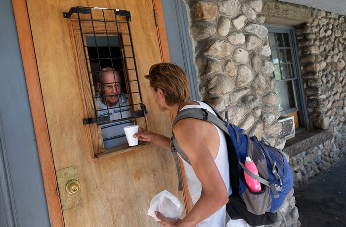 (Francisco Kjolseth  |  The Salt Lake Tribune)  Scott Helferty, a volunteer at the Good Samaritan House at 347 E. South Temple hands out sack lunches on Tuesday, Aug. 27, 2019. After 32 years of serving sack lunches 365 days a year for 11 hours a day to Utah's poor, the Good Samaritan will be closing down, absorbed into the Catholic church's operations at St. Vincent's.