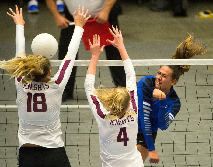 (Rick Egan  |  The Salt Lake Tribune)   Pleasant Grove Vikings Kazna Tarawhiti (16) hits the ball, as Pleasant Grove Vikings Megan Sintay (18) and Alia Rasmussen (4), defend, in 6A volleyball championship action, Pleasant Grove vs. Lone Peak, at Utah Valley University, Saturday, November 4, 2017.