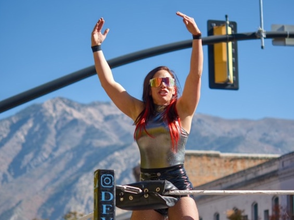 (Michael Serrano) Benita Jean, the wrestling alter ego of Jeanette Langston, hypes up the crowd at a Dia de los Muertos event in Ogden.