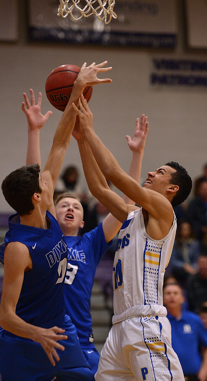 (Leah Hogsten  |  The Salt Lake Tribune) Cyprus' Josh Amasio fights to get to the net over Dixie's Derek Cox. Dixie High School defeated Cyprus High School boys' basketball team 59-52 during the Riverton Holiday Tournament in Riverton, December 28, 2017. 