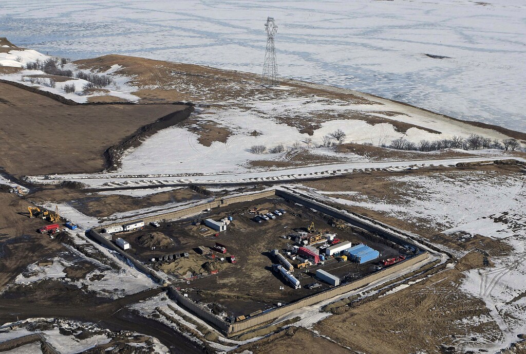 FILE - This Feb. 13, 2017, aerial file photo shows a site where the final phase of the Dakota Access Pipeline near the Missouri River took place with boring equipment routing the pipeline underground and across Lake Oahe to connect with the existing pipeline in Emmons County in Cannon Ball, N.D. A federal judge on Monday, Dec. 4, 2017, ordered the Army Corps of Engineers and pipeline developer Energy TransFer Partners to complete an oil spill response plan for a section of the pipeline beneath the Missouri River in North Dakota. (Tom Stromme/The Bismarck Tribune via AP, File)