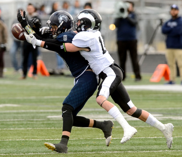 (Steve Griffin  |  The Salt Lake Tribune)  Corner Canyon wide receiver Colton Lawson can't make a catch as Highland defender Matthew Lloyd breaks up the play during the Class 5A state quarterfinal football game at Corner Canyon in Draper Friday November 3, 2017.