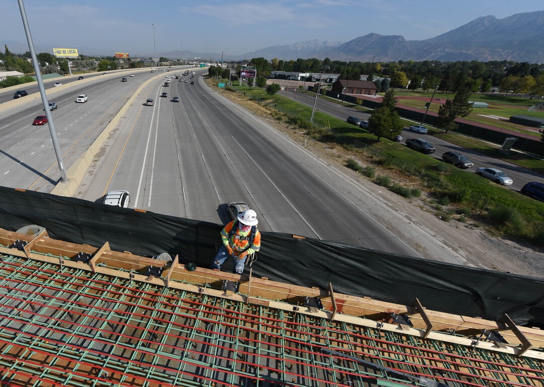 (Francisco Kjolseth  |  The Salt Lake Tribune) UDOT gives a tour of the state’s new longest pedestrian bridge on Thursday, August 20, 2020, connecting Utah Valley University in Orem to student housing and the community on the West side of I-15. Crews are finishing up an extensive hydronic heating system that will pump warm water to keep the bridge clear of snow in the winters, as it gets ready to pour concrete for the walking surface. UDOT will close I-15 in both directions this weekend for work on the nearly 1,000 foot bridge that is 15 feet wide to accommodate pedestrians, cyclists and scooters. Elevators and stairs with small ramps to push up bicycles will be on each side of the bridge.