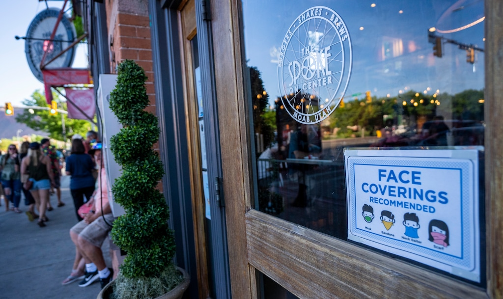 (Rick Egan | The Salt Lake Tribune)  A sign recommending face coverings, on the door of The Spoke On Center, on Street in Moab, on Friday, May 14, 2021.