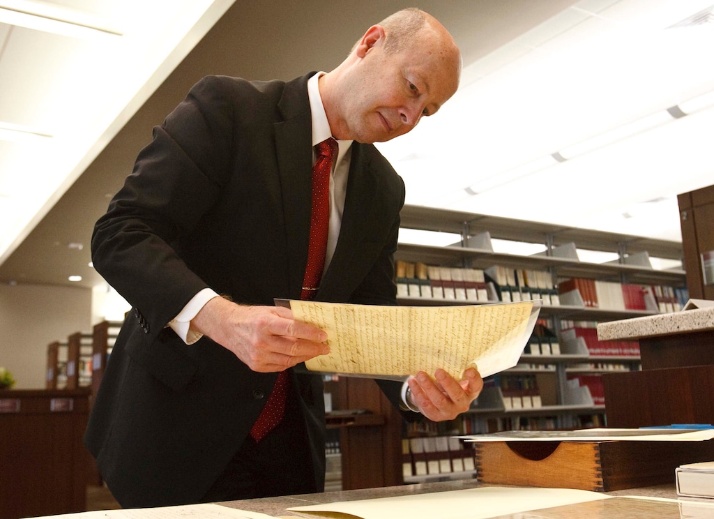 (Leah Hogsten | Tribune file photo) Richard Turley holds one of Joseph Smith's personal documents during a news conference to announce a release in the "Joseph Smith Papers" project in 2013.  Turley recently retired.
