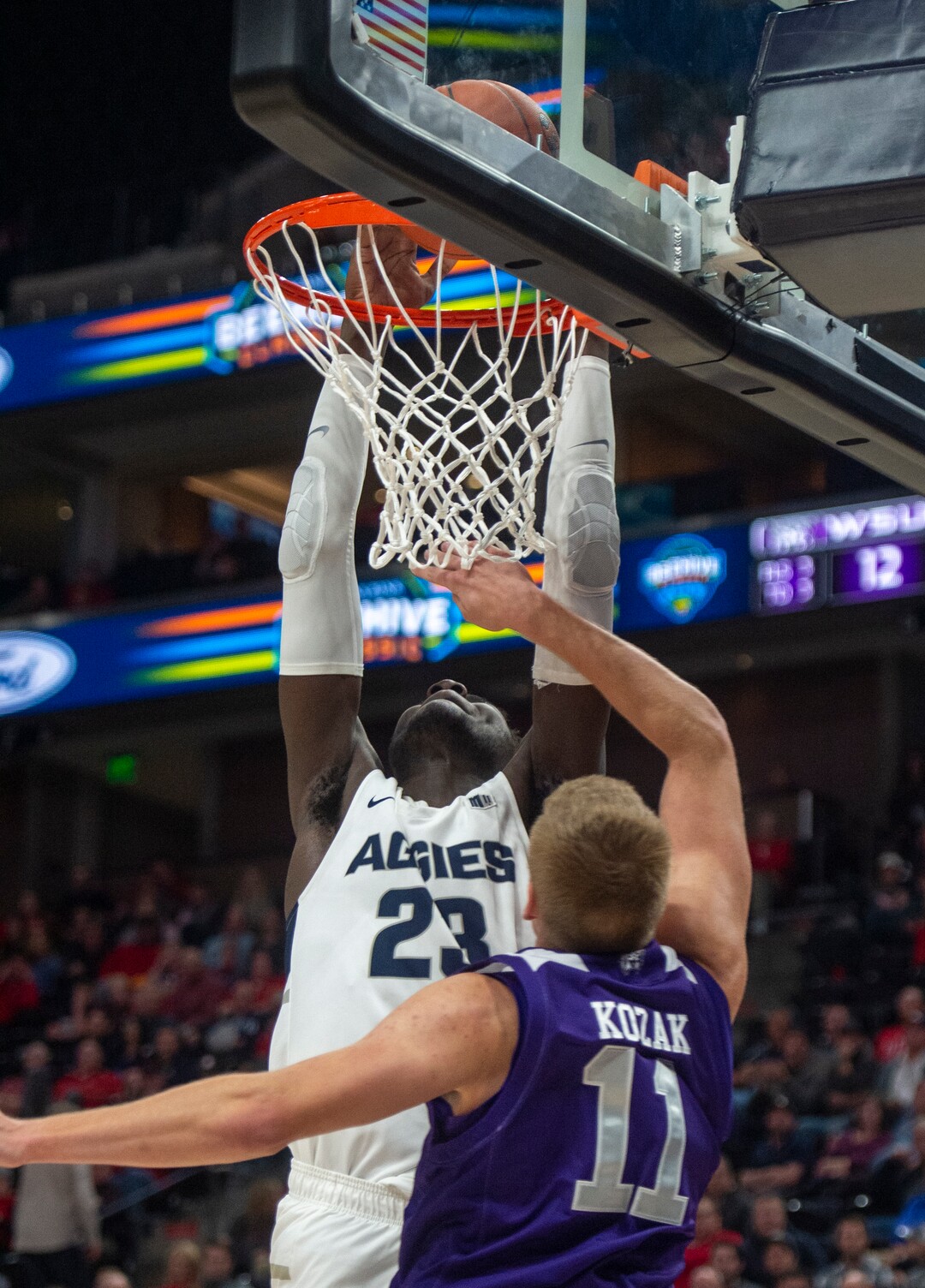 (Rick Egan  |  The Salt Lake Tribune)   Utah State Aggies center Neemias Queta (23) dunks the ball, as Weber State Wildcats forward Michal Kozak (11) defends, in basketball action in the Beehive Classic, between against the Utah State Aggies and Weber State Wildcats, a the Vivint Smart Home Arena, Saturday December 8, 2018. 