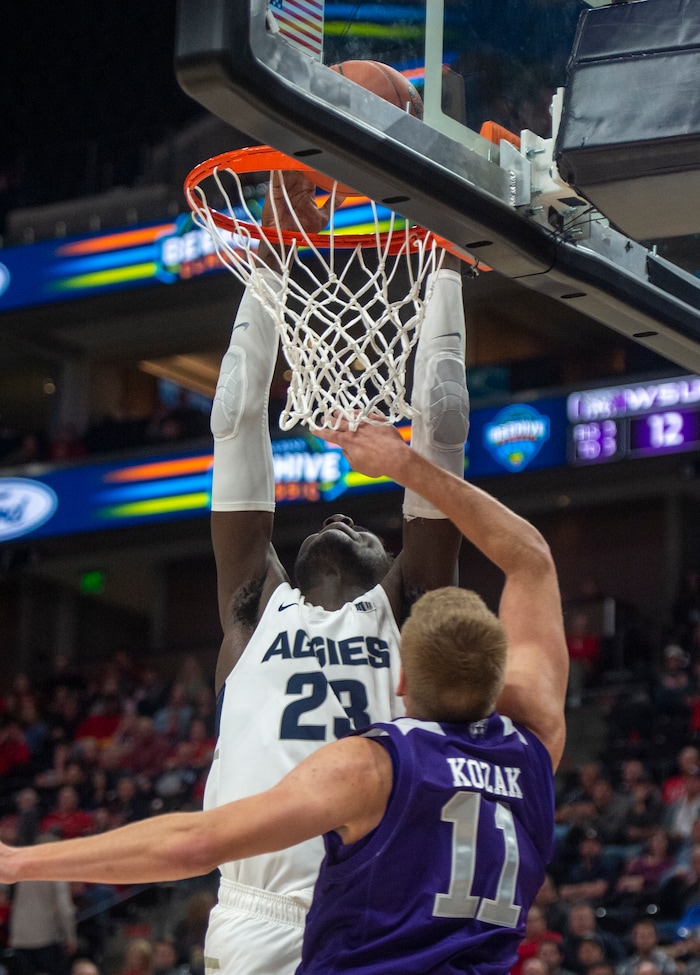 (Rick Egan  |  The Salt Lake Tribune)   Utah State Aggies center Neemias Queta (23) dunks the ball, as Weber State Wildcats forward Michal Kozak (11) defends, in basketball action in the Beehive Classic, between against the Utah State Aggies and Weber State Wildcats, a the Vivint Smart Home Arena, Saturday December 8, 2018.

 