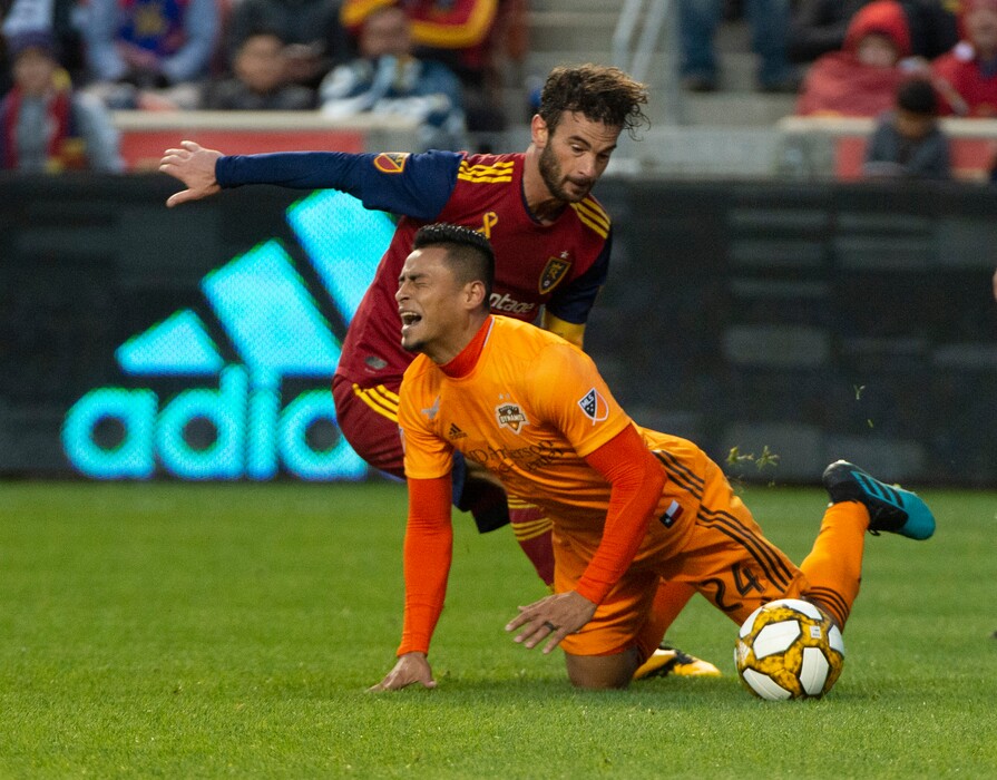  (Rick Egan  |  The Salt Lake Tribune)      Houston Dynamo midfielder Darwin Ceren (24) hits the ground after colliding with Real Salt Lake midfielder Kyle Beckerman (5), in MLS soccer action, between Real Salt Lake and Houston Dynamo, at Rio Tinto Stadium, Sunday, Sept. 29, 2019.