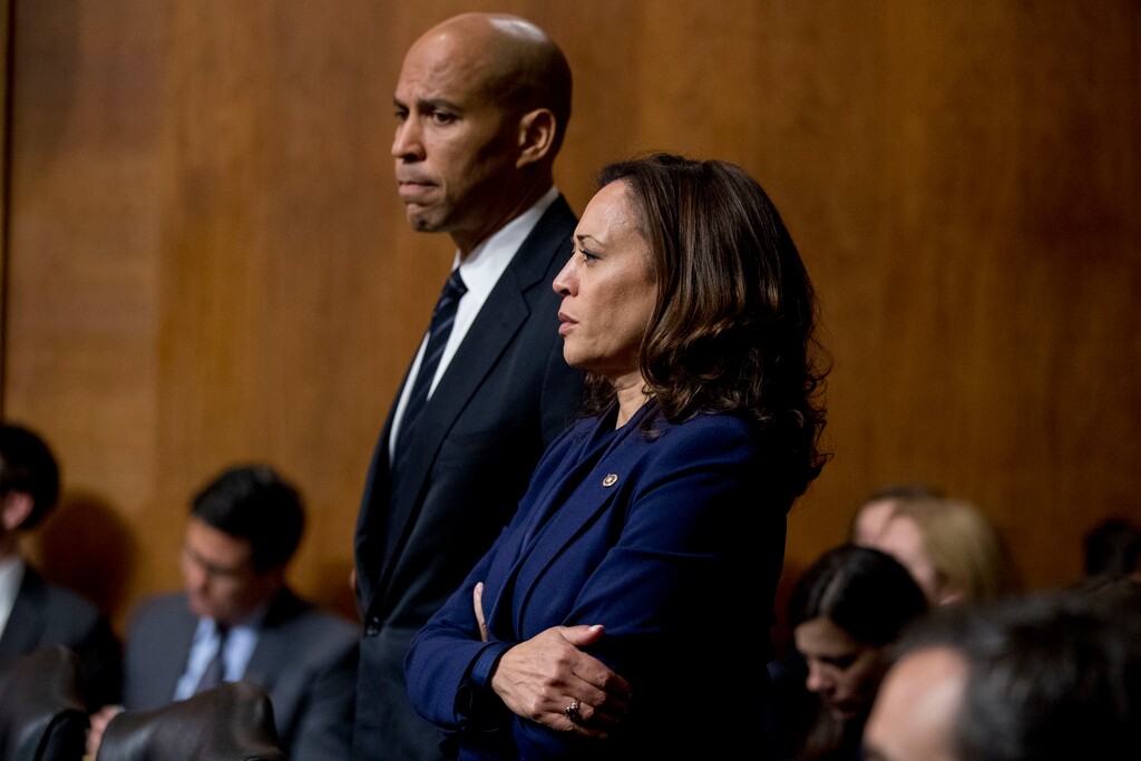 Sen. Cory Booker, D-N.J., and Sen. Kamala Harris, D-Calif., listen as Sen. Jeff Flake, R-Ariz., speaks during a Senate Judiciary Committee hearing on Supreme Court nominee Judge Brett Kavanaugh, Friday, Sept. 28, 2018, on Capitol Hill in Washington. The committee advanced Brett Kavanaugh's nomination for the Supreme Court after agreeing to a late call from Flake for a one week investigation into sexual assault allegations against the high court nominee. (AP Photo/Andrew Harnik)